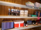 many baskets and boxes on the shelves in the room