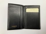 an image of a black leather wallet with a credit card in it