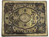a gold and black box with a floral design on it