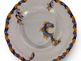 an image of a blue and yellow plate with a dragon on it