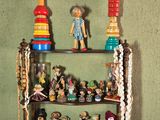 a shelf that has a lot of figurines on it
