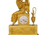 an image of a golden clock with an angel sitting on top of it