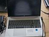 two laptops sitting on a desk next to each other