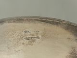 a silver plate with a handle on a table