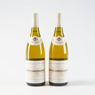 deux bouteilles de vin posées l'une à côté de l'autre sur une surface blanche