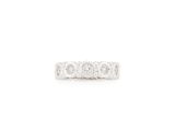 a white gold ring with three diamonds on the side