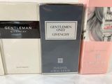 three boxes of perfume sitting on top of a white table