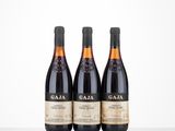 three bottles of wine sit on a table in front of a white background