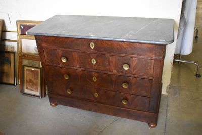 a dresser with a marble top in the middle of a room