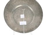 a silver plate on a clear stand on a white background
