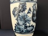 a blue and white vase sitting on a table