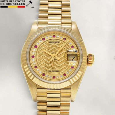 an image of a gold wrist watch with diamonds on the dial