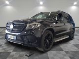 the mercedes gls is parked on a checkered floor in a garage