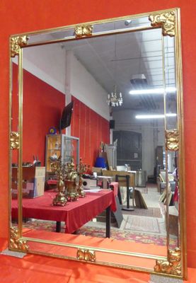 a mirror that is sitting on a table in a room