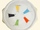 a white plate with a multicolored design on it
