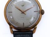 an image of a close up of a wrist watch on a white surface