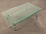 rectangular glass coffee table with metal legs and a glass top