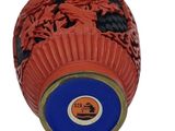 a red ball with black and orange designs on it