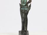 a bronze statue of a man holding a book in his hands