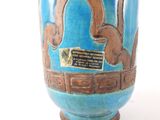 a blue vase with a picture of a monkey on it