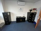 an image of a room with a desk, filing cabinet, and a tv
