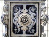 a blue and white tile with a decorative design on it