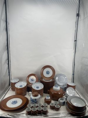 many plates and cups sitting on a table in a box