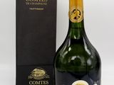 a bottle of champagne with a box of chocolates in the background