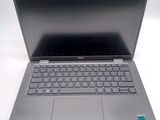 an open laptop computer sitting on top of a white table
