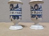 two salt and pepper shakers sitting on a table
