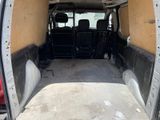 the back of a van with the door open and the seats down