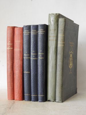 several books are lined up in a row on a table
