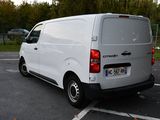 a white van that is parked in a parking lot