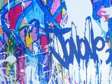 a picture of a wall with graffiti on it that says time