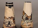 two vases that have been decorated with a picture of a man on horseback