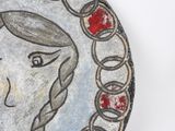 a painting of a woman with braids on a plate