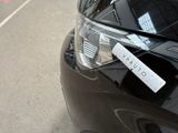 a sticker on the hood of a car that is parked on the side of the road