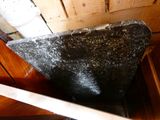 a black stone toilet sitting in a wooden room