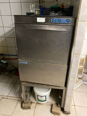 an image of a dirty kitchen with a dishwasher in the corner