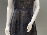 an image of a mannequin wearing a black dress and white tights