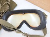 a pair of goggles sitting on a table next to a bag