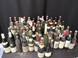 many bottles of wine that are sitting on a table