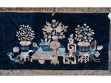 an image of a blue rug with a picture of a train and flowers on it