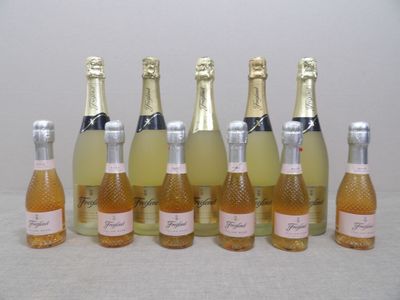 six bottles of champagne are lined up in a row on a table