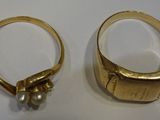 two gold rings with pearls on them sitting next to each other