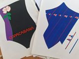 two envelopes with different designs on them sitting on a table