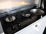 a black stove top with two burners on it
