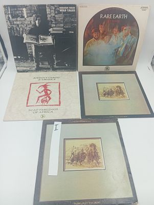 trois disques encadrés posés sur une table, avec la photo d'un homme et d'une femme