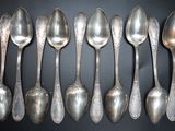 a lot of spoons that are lined up on the table