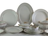 a lot of white plates and bowls on a table